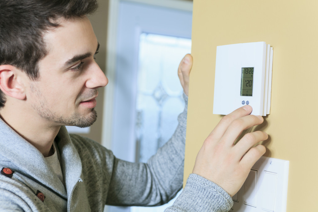 a man setting his thermostat